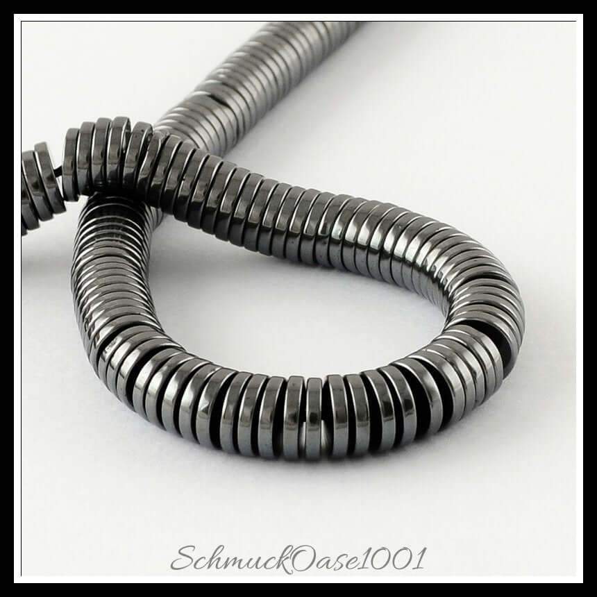 Synthetische hämatitperlenstränge – flachrund / 6x1 mm / ca. 200 stück, aus synthetischer hämatit / flachrund, unmagnetisch in der farbe grau und größe 6x1 mm, loch: 1 mm / ca. 200 stück