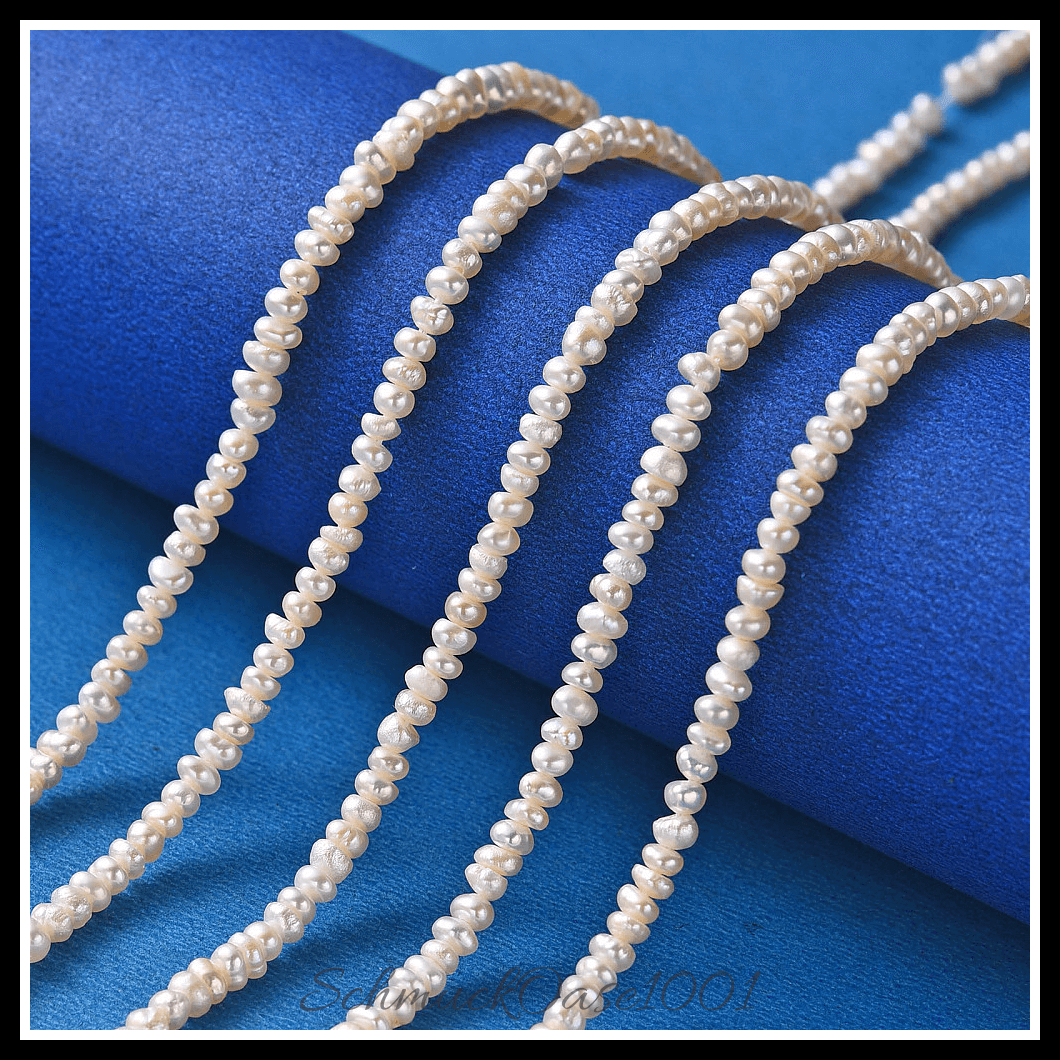 Kultivierte süßwasserperlen stränge – creme-weiß, 2–4 mm (1 strang), aus natürliche süßwasserperlen / zwei seiten poliert in der farbe creme-weiß und größe 2–3 mm, bohrung: 0.8 mm, ca. 190–200 stk./strang